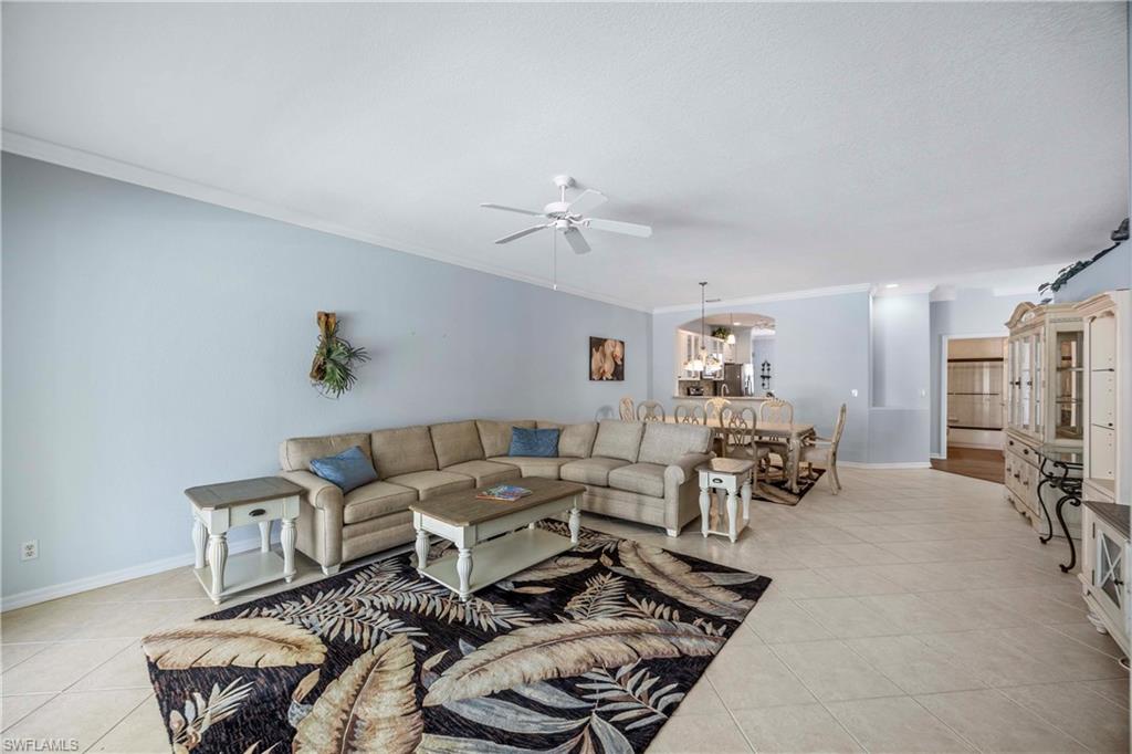 3589 Periwinkle Way Naples, FL 34114 - Photo 7 of 39 a living room with furniture and a chandelier