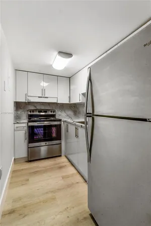 a kitchen with stainless steel appliances granite countertop a stove and a refrigerator