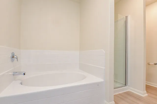 a bathroom with bathtub and shower