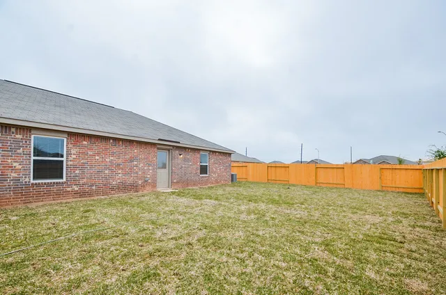 a view of a big room with an empty space and a large window
