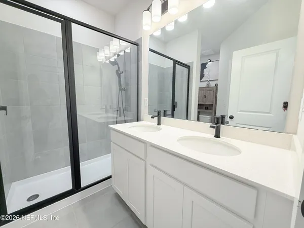 a bathroom with a double vanity sink mirror and double
