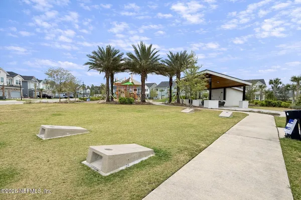 a swimming pool with outdoor seating and yard