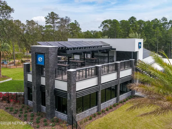 an aerial view of a house with a garden and swimming pool
