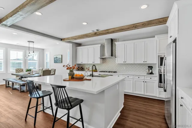 a kitchen with stainless steel appliances white cabinets and a stove a refrigerator