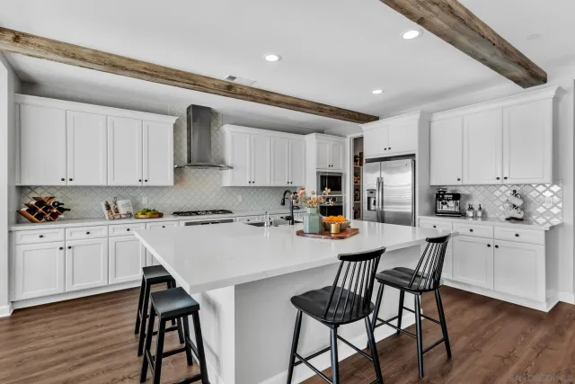 a open dining room with furniture a chandelier and wooden floor