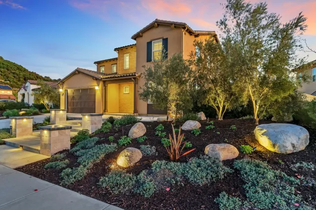 a view of a house with backyard and sitting area