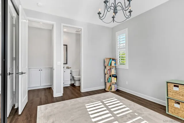 a spacious bedroom with bed and a window