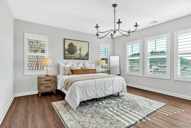 a spacious bathroom with a double vanity sink a mirror a bathtub and window
