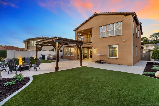 a front view of a house with a garden and patio