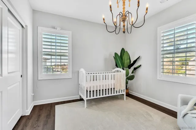 a view of a patio with couches table and chairs with wooden floor