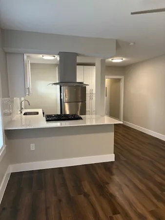 a kitchen with wooden floor