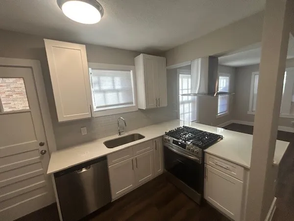 a kitchen with a sink stove and cabinets