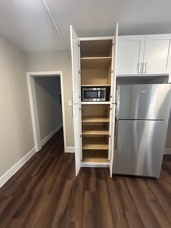 a kitchen with a refrigerator and a stove