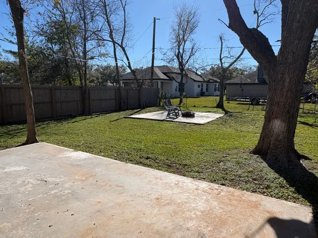a view of a backyard with large trees