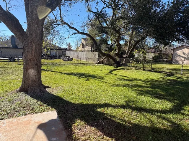 a view of a swimming pool with a yard
