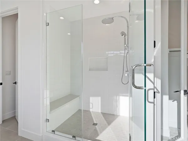 a bathroom with a glass shower door
