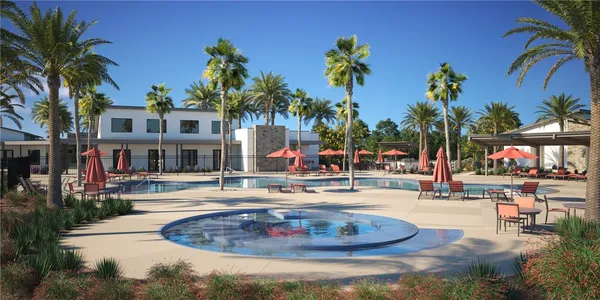 a swimming pool with outdoor seating yard and palm tree