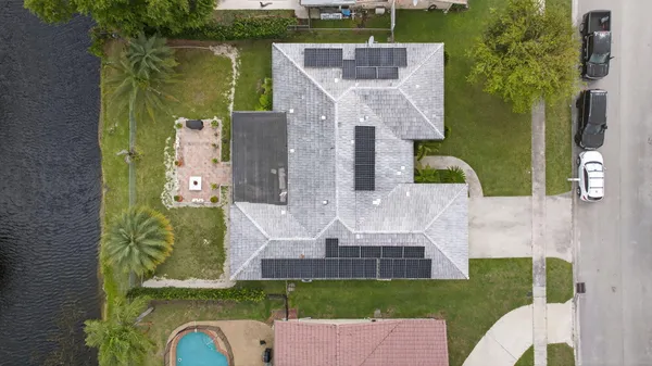 an aerial view of a house with garden space and street view