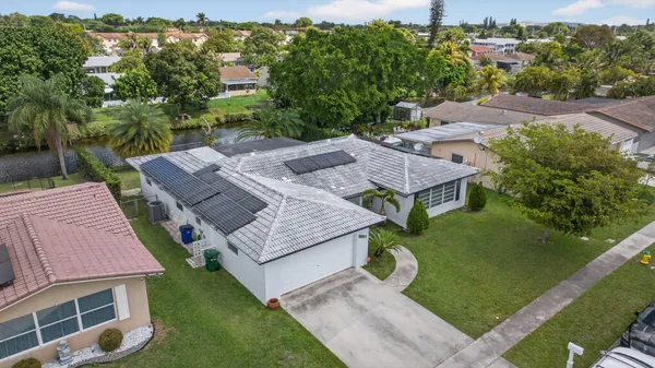 a view of a house with a backyard and sitting area