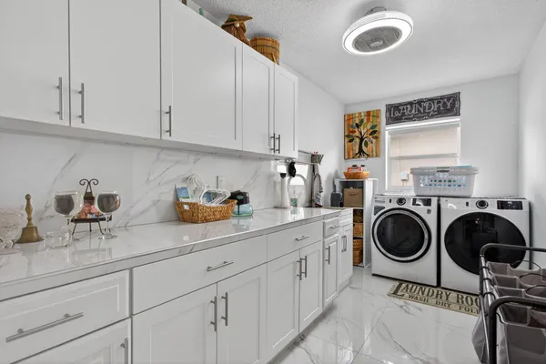 a kitchen island with stainless steel appliances lots of counter space and furniture