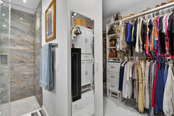 a bedroom with a large bed and a chandelier