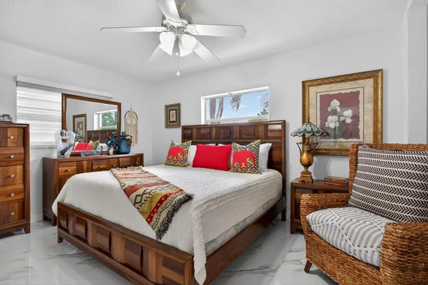 a bedroom with a bed and a wooden floor