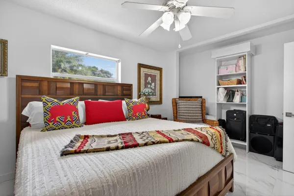 a bedroom with a bed and flat screen tv
