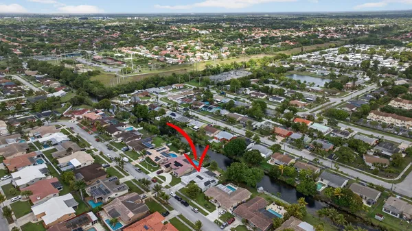 an aerial view of residential building with parking