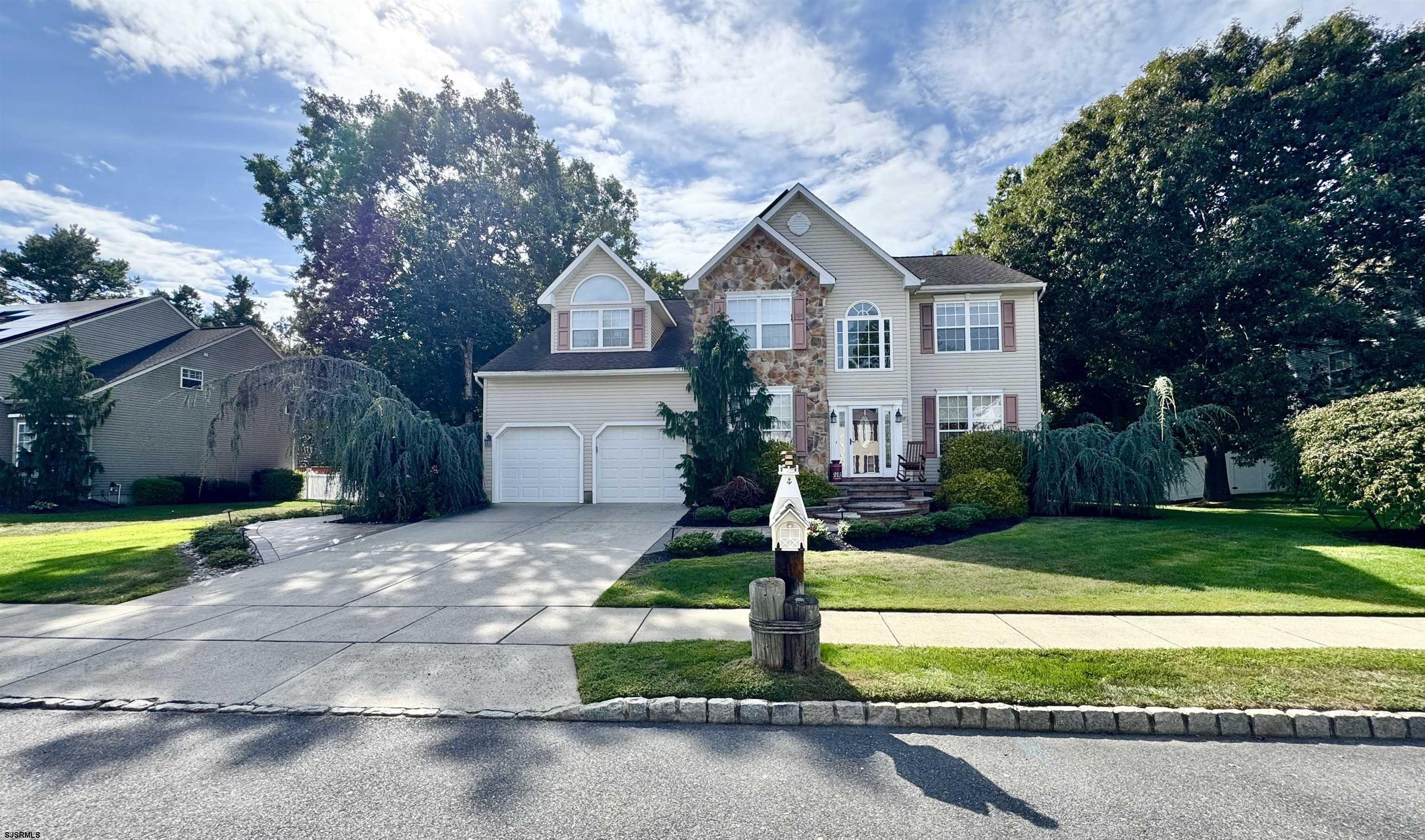 a front view of a house with a yard and garage
