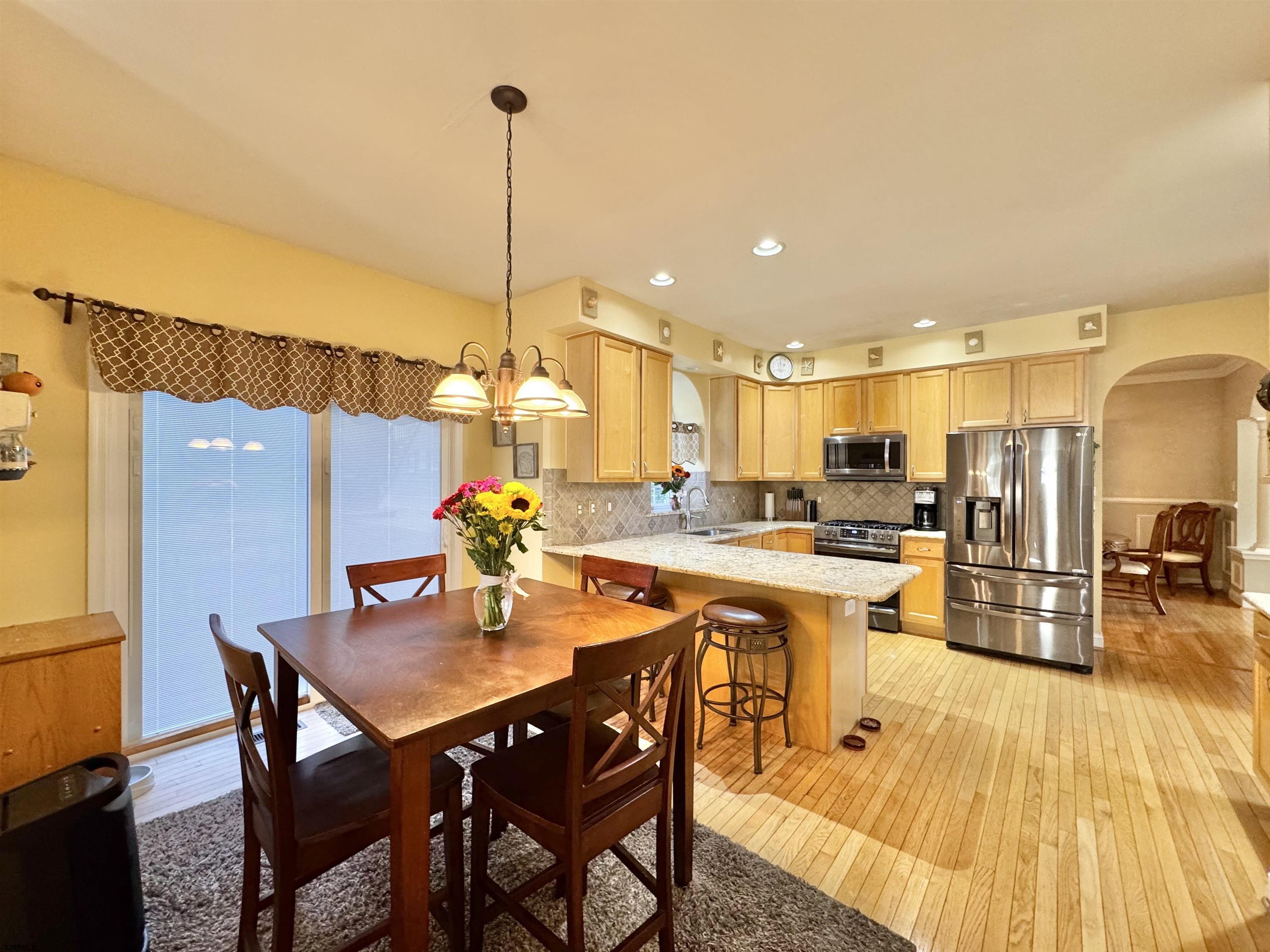 215 Prancer Road Egg Harbor Township, NJ 08234 - Photo 12 of 46 a dining hall with stainless steel appliances kitchen island granite countertop a dining table and chairs