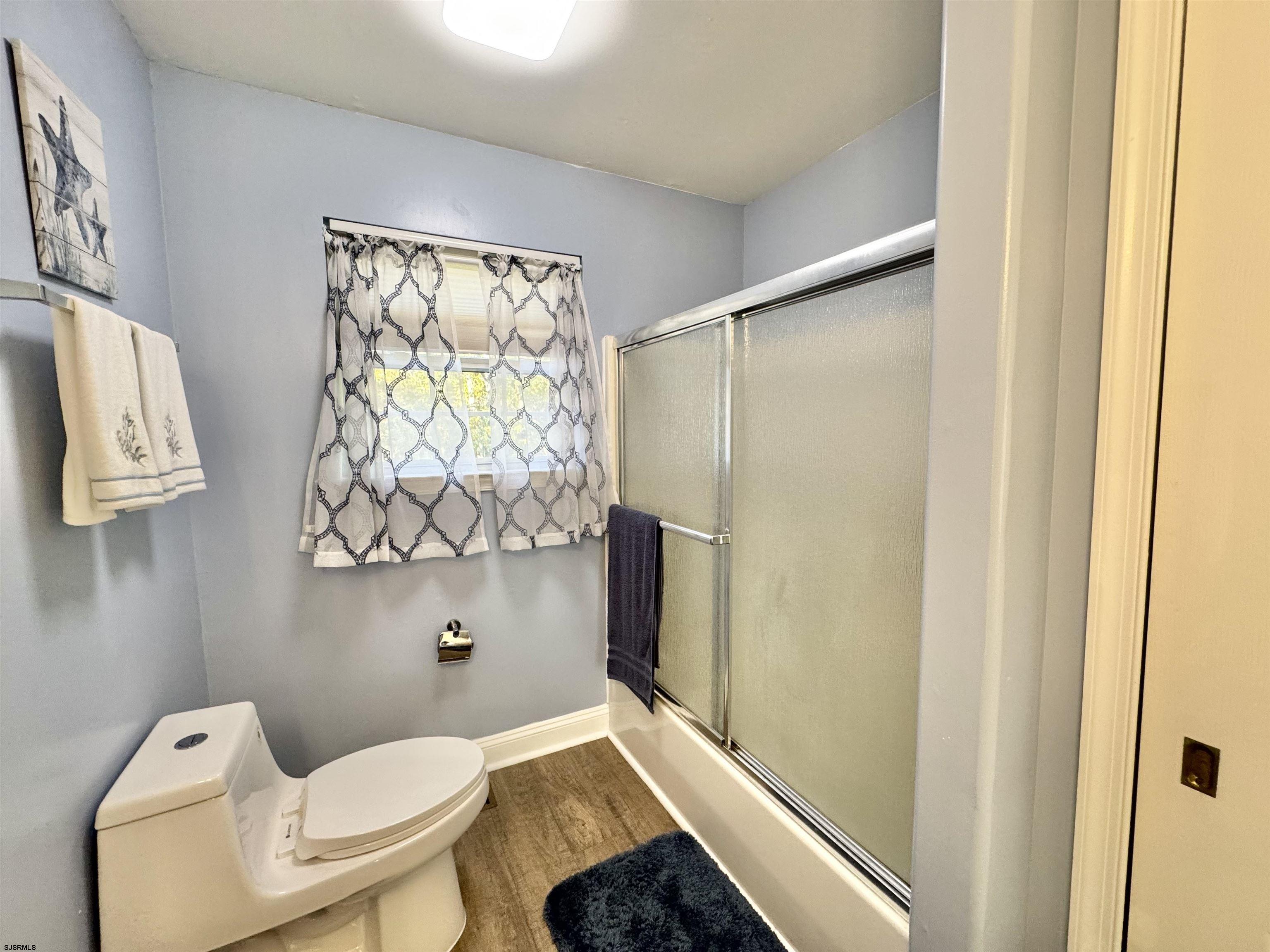 215 Prancer Road Egg Harbor Township, NJ 08234 - Photo 19 of 46 a bathroom with a toilet and a shower curtain