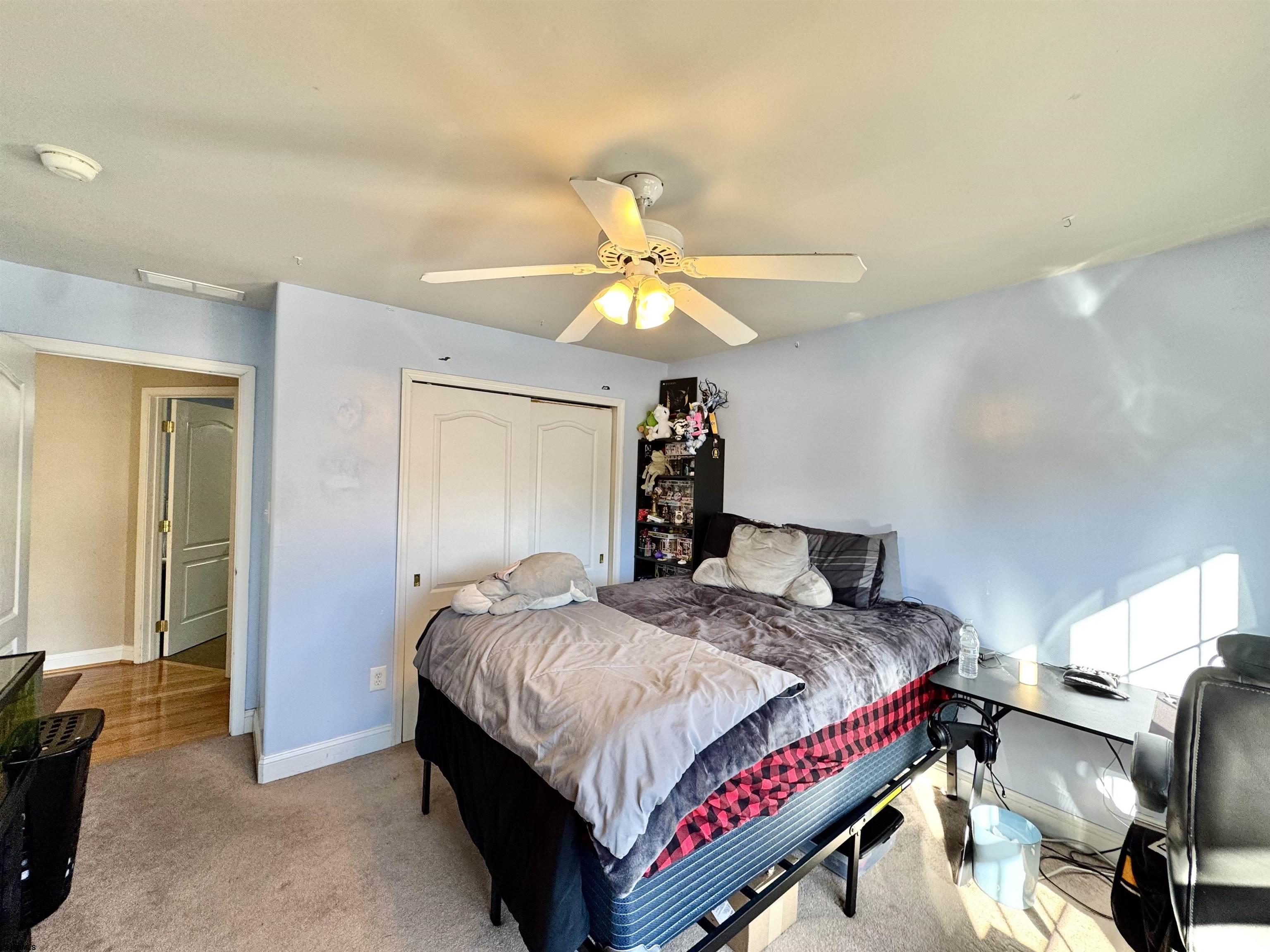 215 Prancer Road Egg Harbor Township, NJ 08234 - Photo 22 of 46 a bedroom with a bed and a chandelier