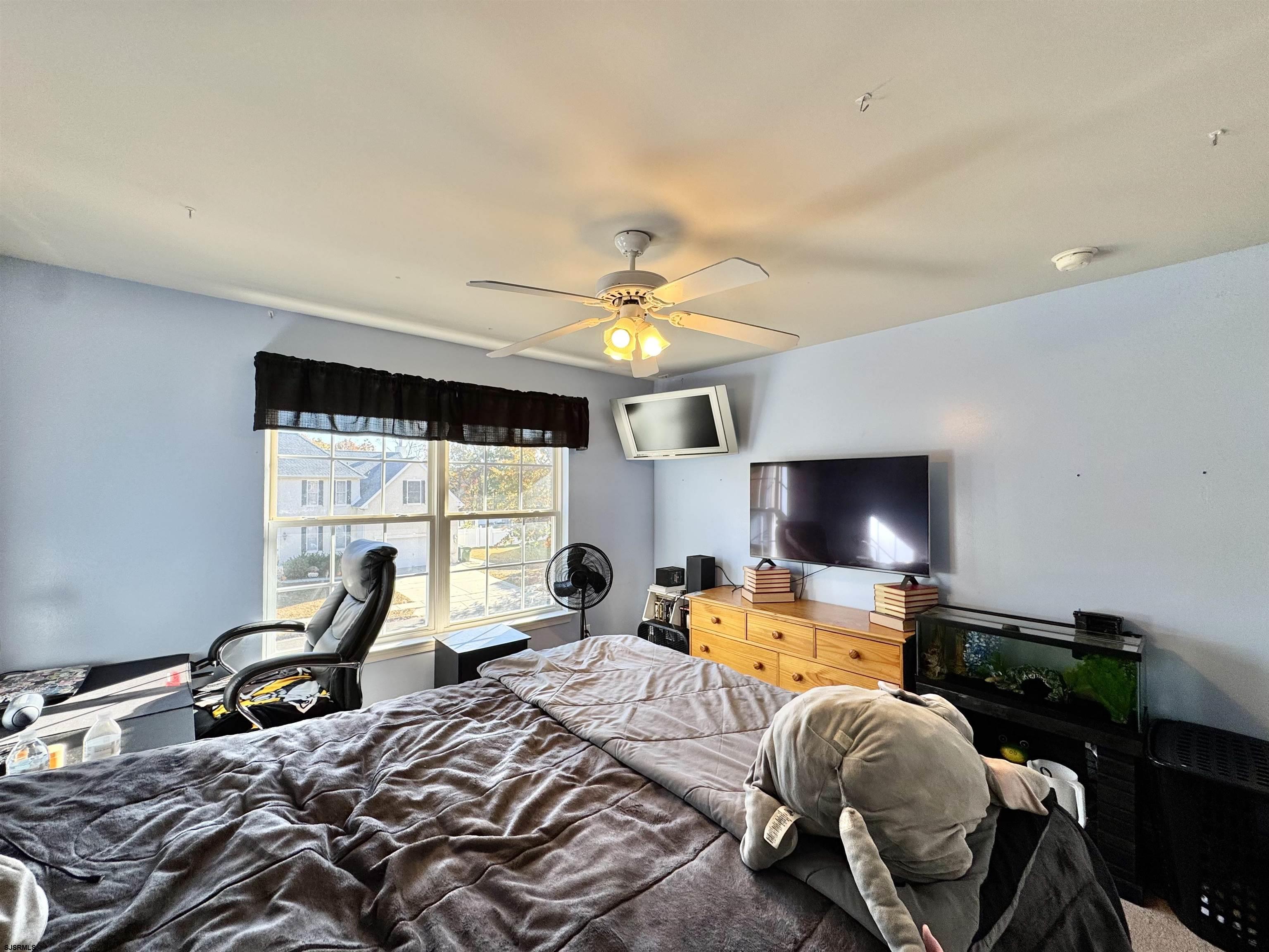 215 Prancer Road Egg Harbor Township, NJ 08234 - Photo 23 of 46 a bedroom with a bed and glass windows