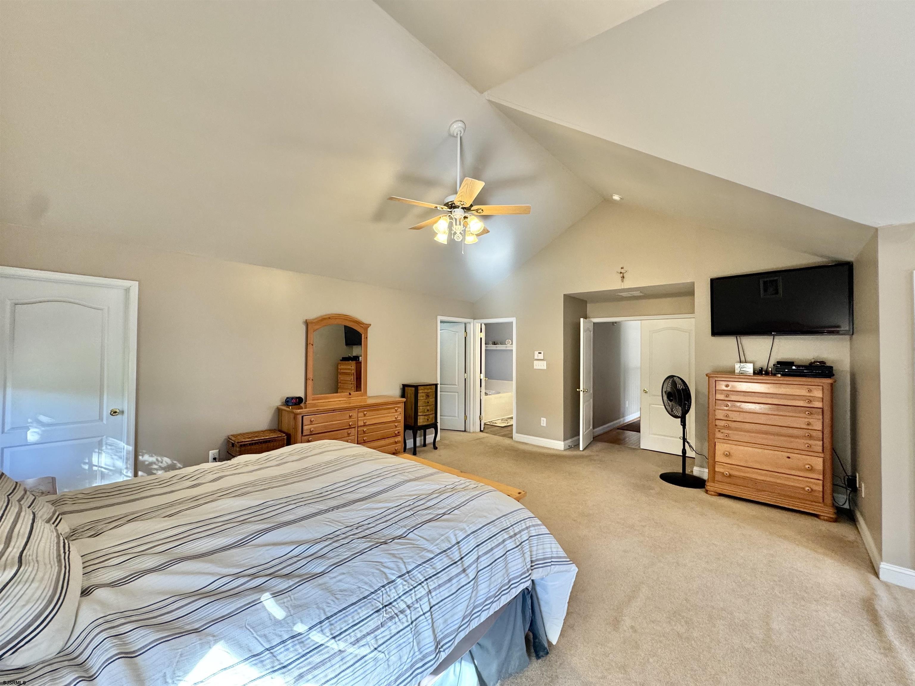 215 Prancer Road Egg Harbor Township, NJ 08234 - Photo 27 of 46 a bedroom with a bed and a flat tv screen on dresser