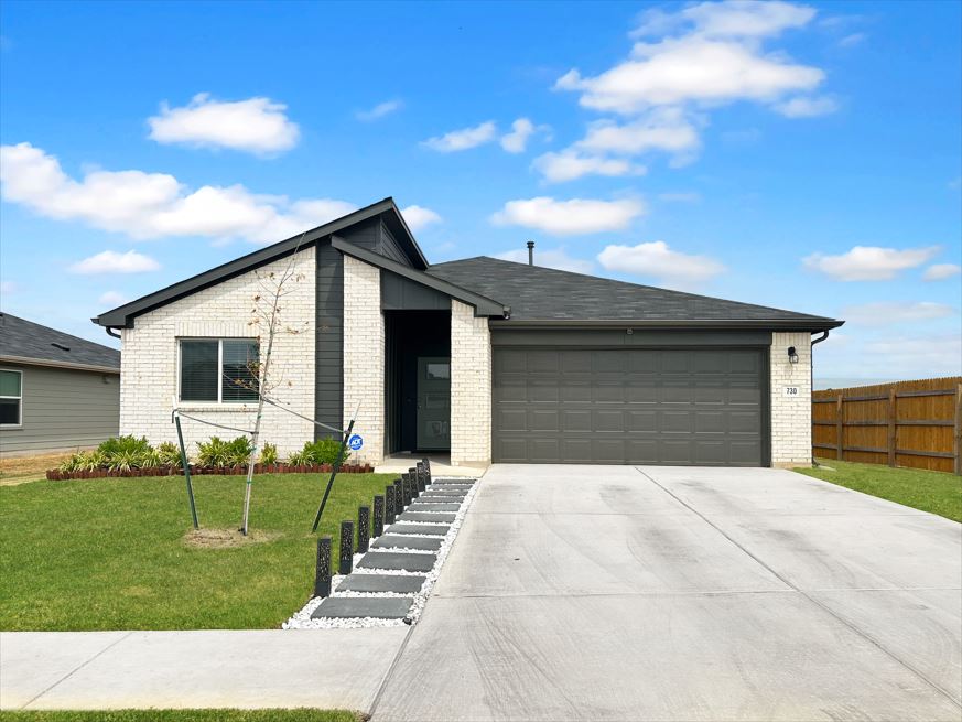 730 Gladiola Loop Kyle, TX 78640 - Photo 1 of 13 View of front of house featuring a garage, driveway, and brick siding