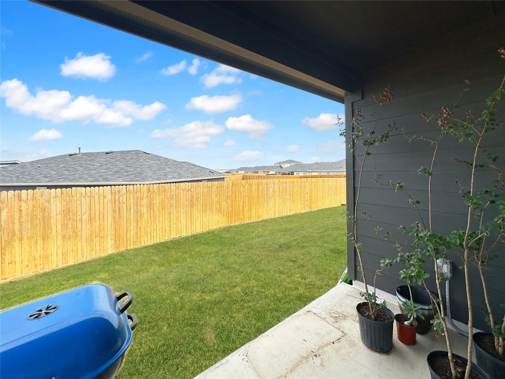 730 Gladiola Loop Kyle, TX 78640 - Photo 11 of 13 Fenced backyard featuring a patio area