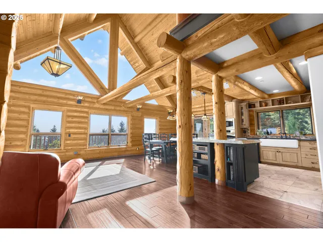 a living room with stainless steel appliances kitchen island granite countertop furniture and a large window