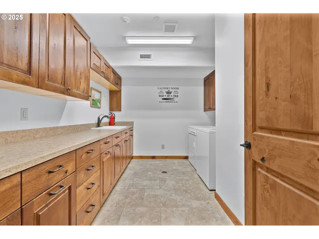 a kitchen with granite countertop a sink window and cabinets