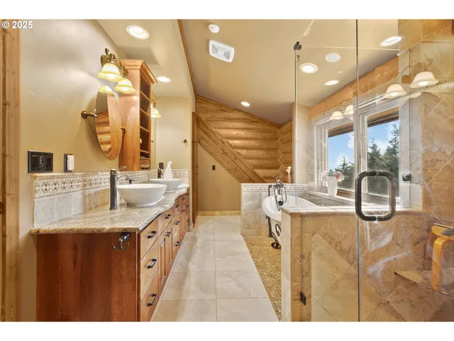 a bathroom with a granite countertop sink a large mirror and a shower