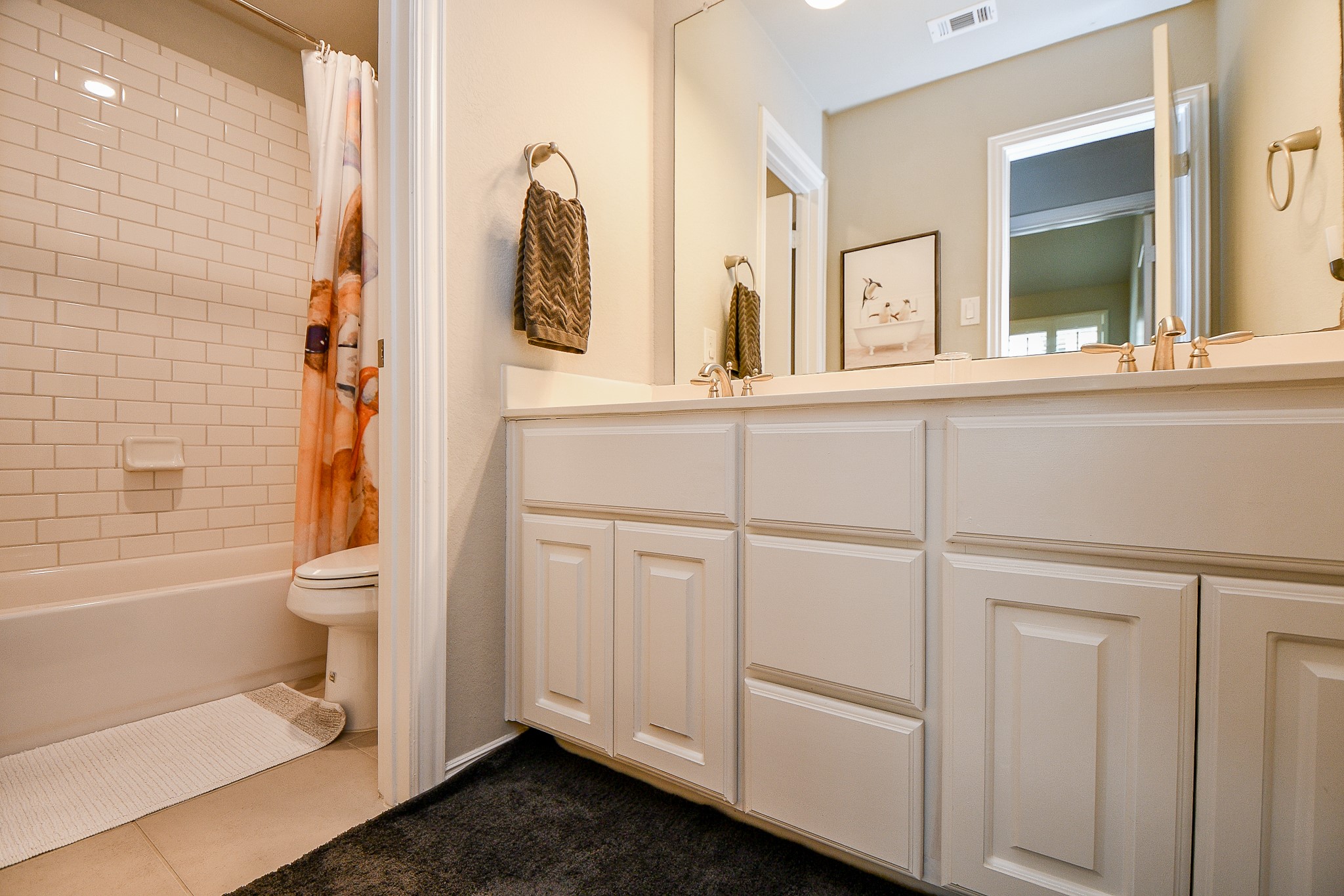 4523 Juniper Ridge Lane Manvel, TX 77578 - Photo 32 of 38 a bathroom with a granite countertop sink a toilet and a bathtub
