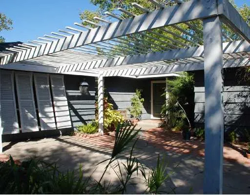 a view of a patio with table and chairs potted plants
