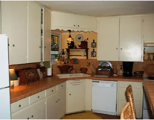 a kitchen with stainless steel appliances granite countertop a sink and cabinets