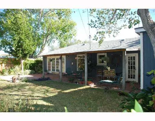 a view of a house with a yard and garden