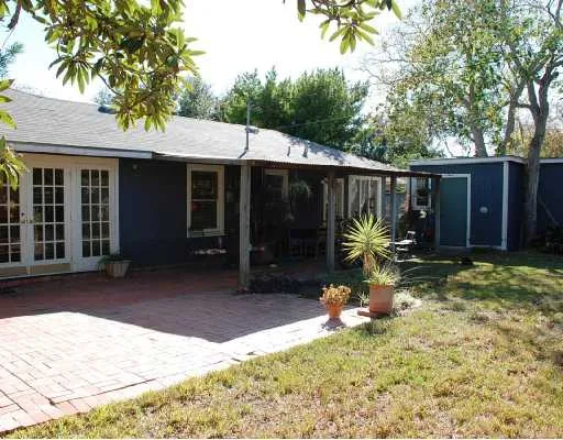 a backyard of a house with yard and outdoor seating