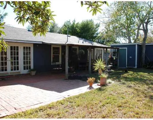 a backyard of a house with yard and outdoor seating