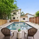 a view of a patio with table and chairs potted plants and wooden fence