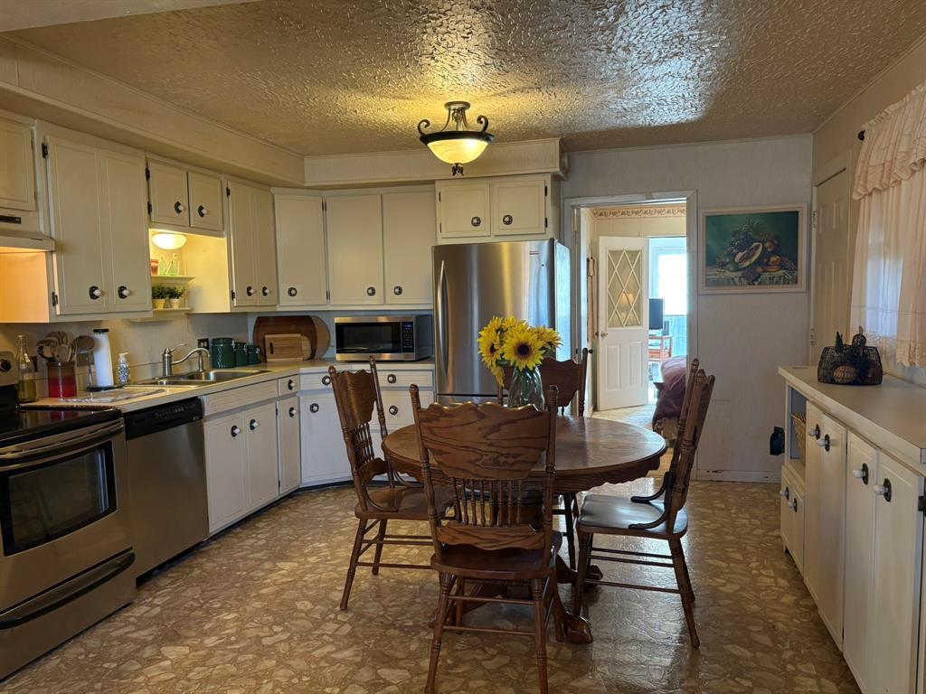 Updated Kitchen is spacious with built in buffet.  Refrigerator conveys. 