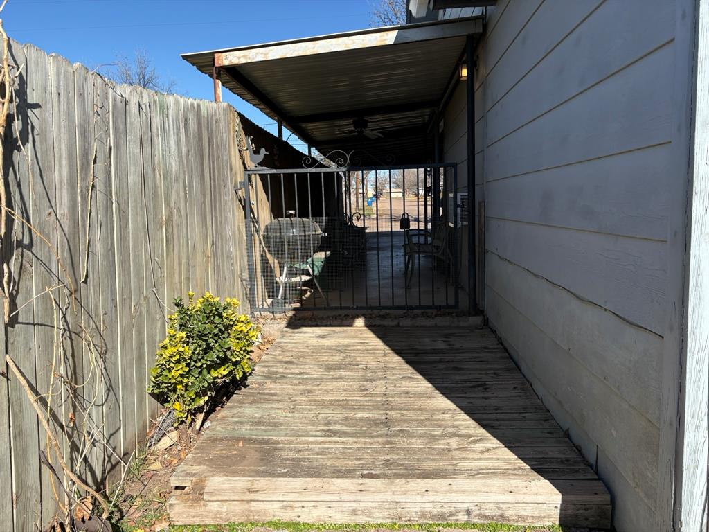 409 East Truett Street Winters, TX 79567 - Photo 18 of 21 Metal gate leads to the deck and backyard!
