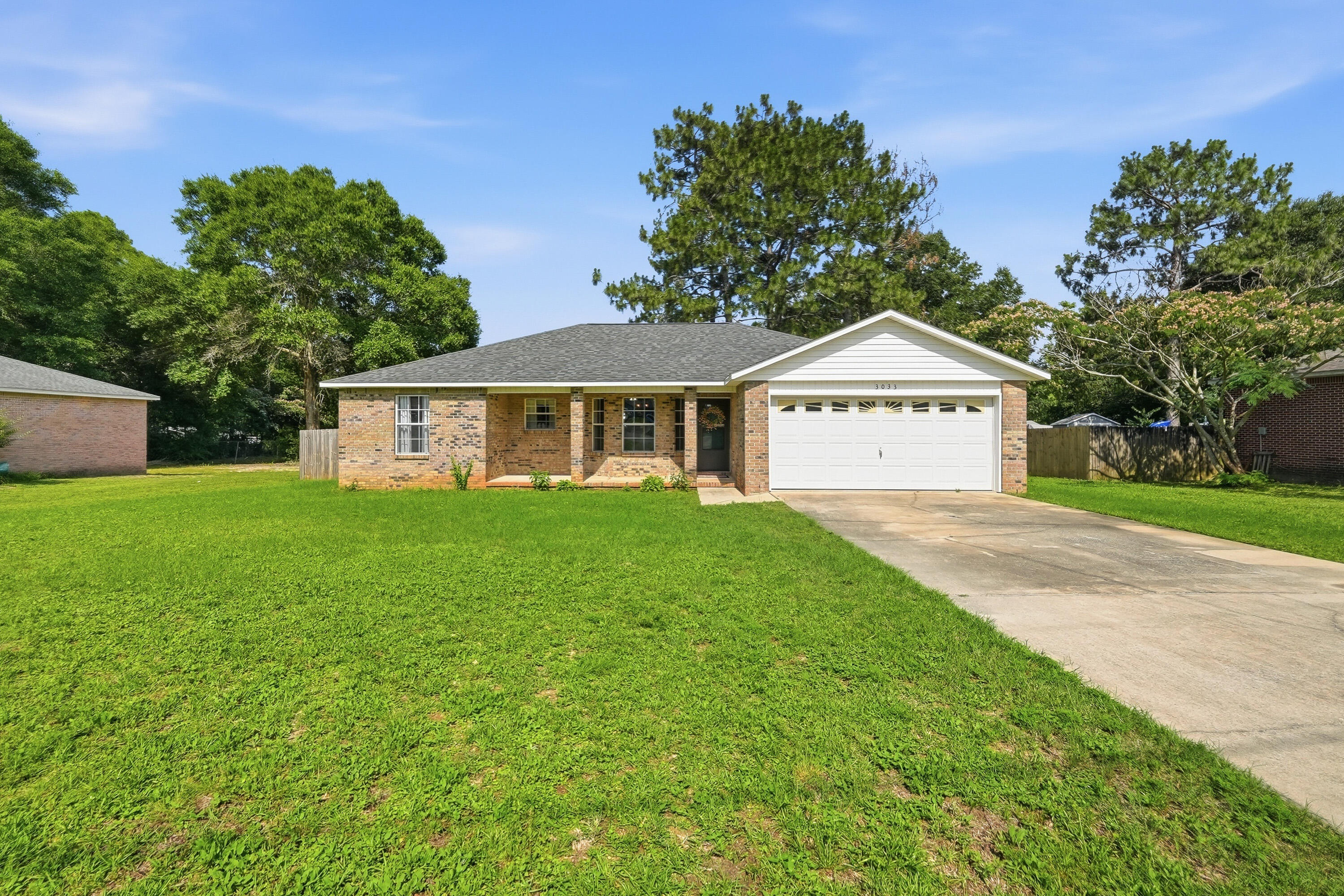 3033 Cabela Lane Crestview, FL 32539 - Photo 25 of 32 a front view of a house with garden