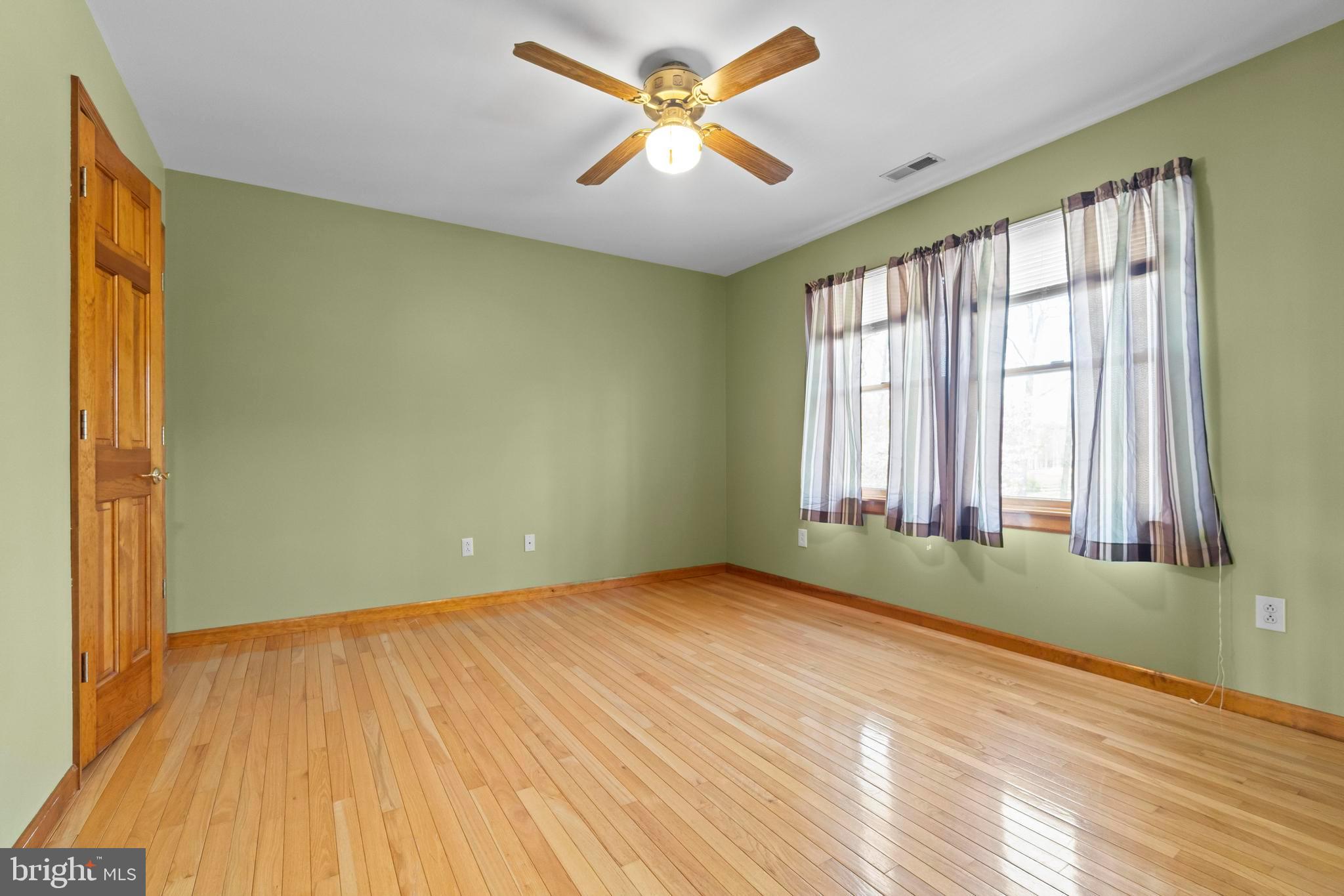 24 Oriental Road Shamong, NJ 08088 - Photo 32 of 67 a view of an empty room with window and a chandelier fan